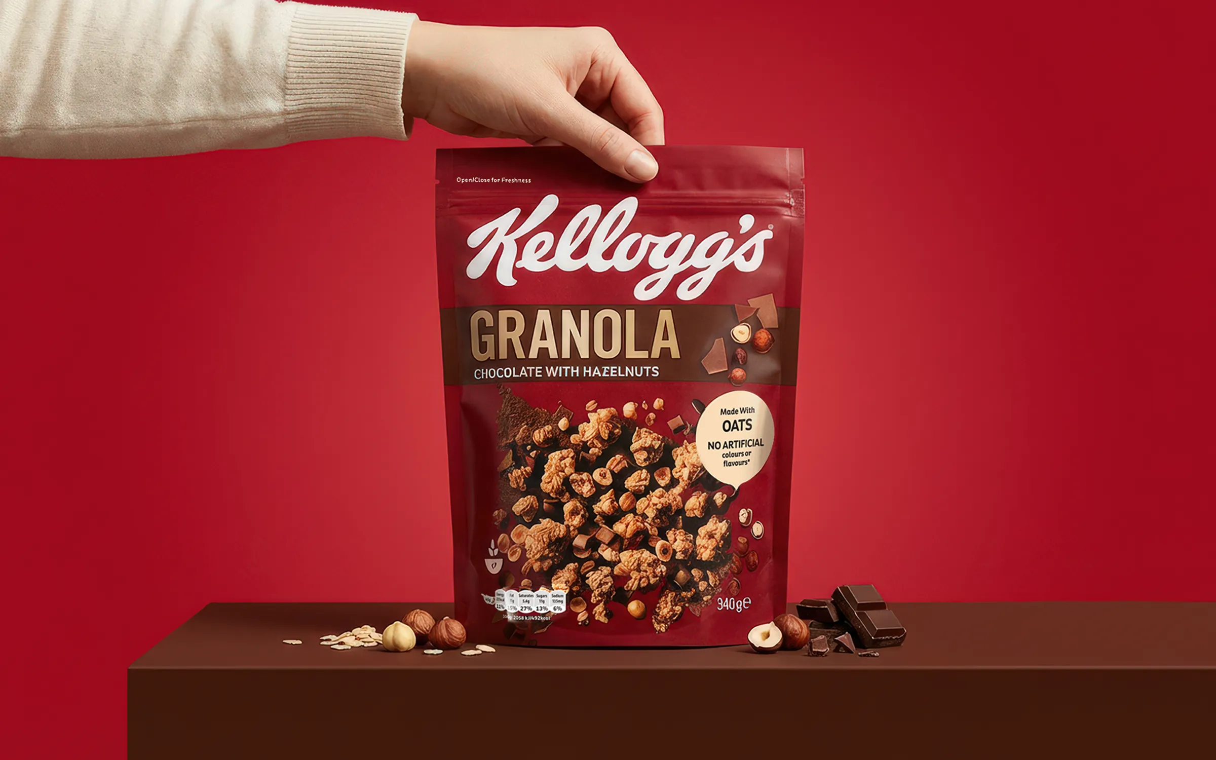 AI-generated studio photo of a hand lifting a granola pack