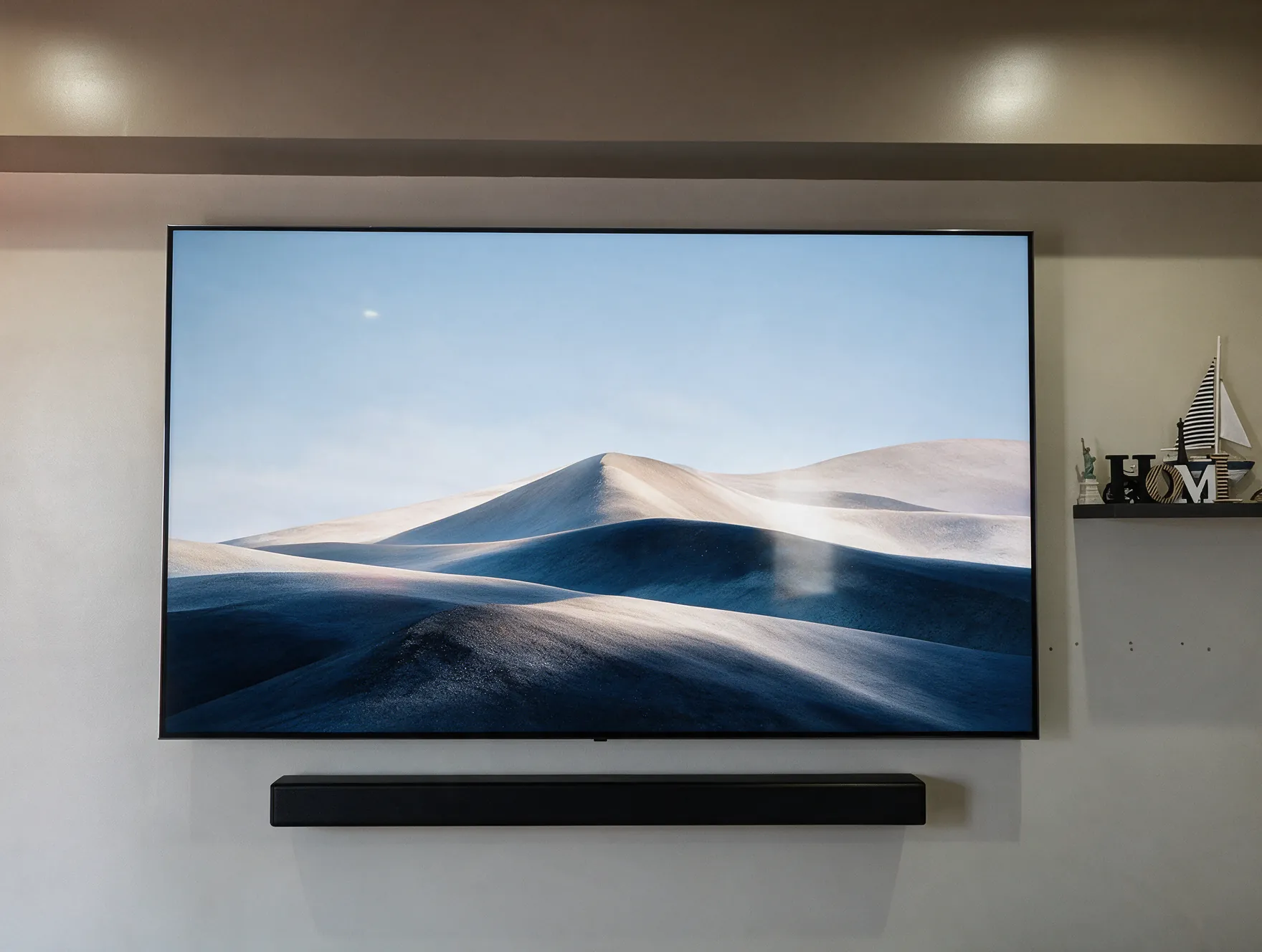 A wall-mounted TV with a soundbar below it